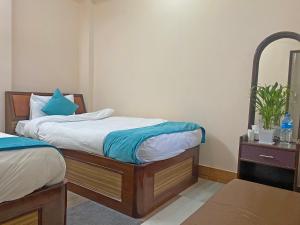 Una cama o camas en una habitación de Hotel Resunga Arjun