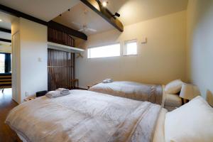 a room with two beds and a window at Sonnet Higashikawa in Higashikawa