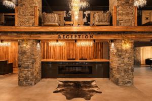 a room with a fireplace and a sign that reads reception at Brentas Spa Resort in Tsigov Chark