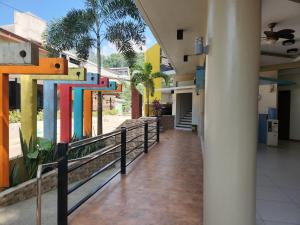 an empty hallway of a building with a hallway at Inngo Tourist Inn in El Nido