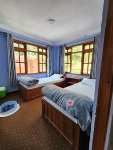 Voodi või voodid majutusasutuse Hotel Garden Inn toas