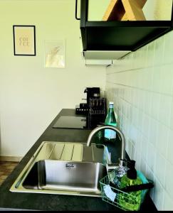 a kitchen sink with a faucet and a counter top at Ferienwohnung Mendig in Mendig +5 photos