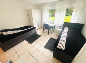a bedroom with two beds and a table and a chair at Ferienwohnung Mendig in Mendig