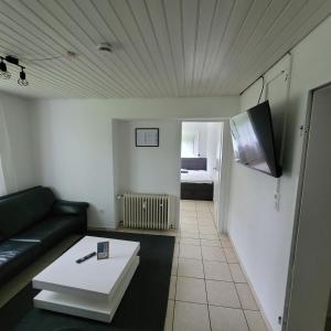 a living room with a couch and a coffee table at Ferienwohnung Mendig in Mendig