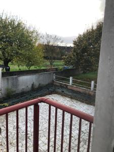 a balcony with a fence and trees in a park at Grande chambre côté jardin in Château-du-Loir