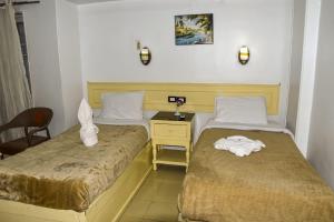 Postel nebo postele na pokoji v ubytování Oscar Hotel + 37 fotografií