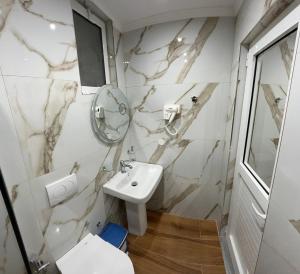 a bathroom with a sink and a mirror at Levend Apartments in Ksamil +39 photos
