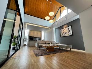 a living room with a couch and a table at Riverla Villa in Krabi