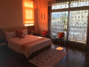 Postel nebo postele na pokoji v ubytování Jing Xiang Hua Nong B&B
