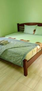 a bedroom with a large bed with a wooden frame at GREEN LAND Resort in Ban Bang Bao