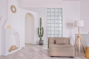 a living room with a chair and a cactus at CHENGDU Liaofan Design B&B Houwu Temple Jinli Twin Suite Ximenqiao Street Morogo White Castle HD Projection LOFT Double Floor Bnb High-Quality Housing in Chengdu