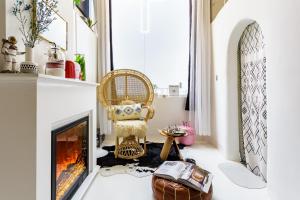 a living room with a fireplace and a chair at CHENGDU Liaofan Design B&B Houwu Temple Jinli Twin Suite Ximenqiao Street Morogo White Castle HD Projection LOFT Double Floor Bnb High-Quality Housing in Chengdu