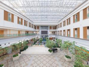 an indoorrium of a building with potted plants at ART HOTEL Kashima Central in Kamisu