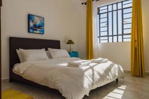 Giường trong phòng chung tại Bechan Homes