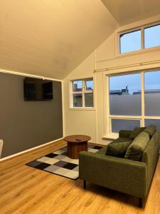 a living room with a couch and a table at The Vík Inn by Ourhotels in Vík