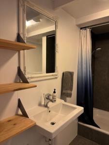 a bathroom with a sink and a mirror and a shower at The Vík Inn by Ourhotels in Vík +37 photos