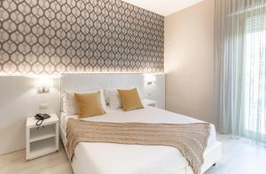 Postel nebo postele na pokoji v ubytování Hotel Biancamano
