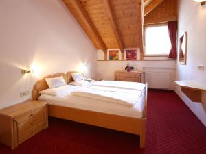 a bedroom with a large bed and a window at Residence Rose in San Candido