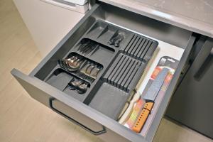 a drawer in a refrigerator filled with utensils at Central location LOFT Apartment in Avcılar