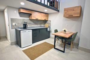 a small kitchen with a wooden table and a counter at Central location LOFT Apartment in Avcılar +10 photos