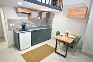a small kitchen with a table and a sink at Central location LOFT Apartment in Avcılar