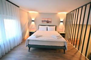 a bedroom with a bed with two towels on it at Central location LOFT Apartment in Avcılar