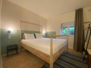 a bedroom with a large bed and a window at Quinta da Cerejeira in Ferreira do Zêzere +45 photos