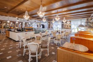 a restaurant with tables and chairs and a bar at Kremlin Palace in Lara