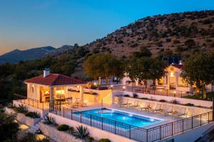 a home with a swimming pool and a house at Villa La Meravigliosa in Vodice