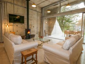 a living room with white furniture and a fireplace at Standby Generator Bunker in Dorchester