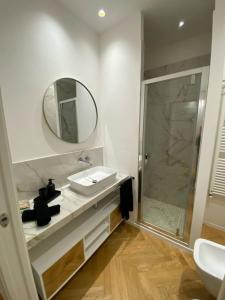 a bathroom with a sink and a mirror and a shower at La Nicchia in Bologna +12 photos
