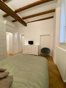 a bedroom with a bed and a desk and a chair at La Nicchia in Bologna