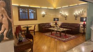 a living room with a couch and a table at Hotel Roma in Bologna