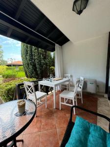 a patio with a table and chairs on a patio at Heritage in Oasis Resort Lozenets in Lozenets