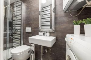 a bathroom with a sink and a toilet and a mirror at Holiday Home Doda in Fažana - 100 m from the Sea in Fažana