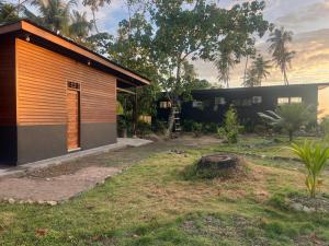 a house with a yard with a building at Villa Pandan Simeulue in Salul +2 photos