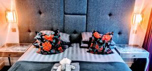 a room with a bed with pillows on it at Boat House Super Suites in Rothesay