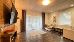 a living room with a television and a couch at Lauku iela 25 in Jūrmala