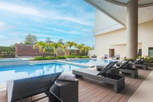 an image of a swimming pool with patio furniture at Royce Hotel & Casino in Clark