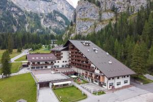 a large building in front of a mountain at Dolomitissime Holiday Homes Marmolada in Rocca Pietore