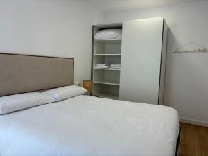 a bedroom with a white bed and a closet at Vivienda turística El Caminante con garaje in Soria
