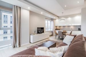 a living room with a couch and a table at Platinum Towers - luxury City Centre apartment with a view in Warsaw