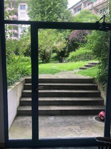 a view of stairs through a glass door at Bright studio in the city center - Greenyard 1 in Zürich +6 photos