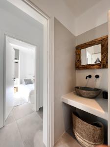 a bathroom with a sink and a mirror at Villa ilios, Stelida Naxos, by NaxosVibe in Naxos Chora +32 photos
