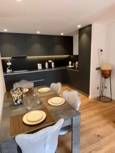 a dining room with a table and white chairs at chalet barcelona in Barcelona