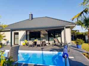 a house with a swimming pool in front of a house at Ferien Marx in Oberbrechen