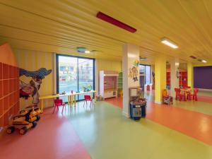 a childrens room with yellow walls and red chairs at Kremlin Palace in Lara