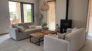 a living room with two couches and a coffee table at Villa Castelina in Vicani