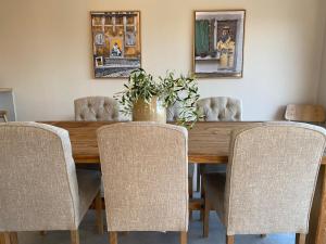 a dining room with a wooden table and chairs at Villa Castelina in Vicani +23 photos