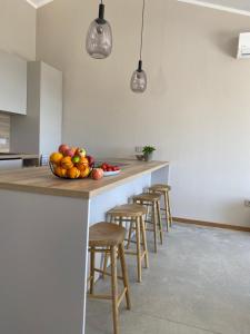 a kitchen with a counter with a bowl of fruit on it at Villa Castelina in Vicani